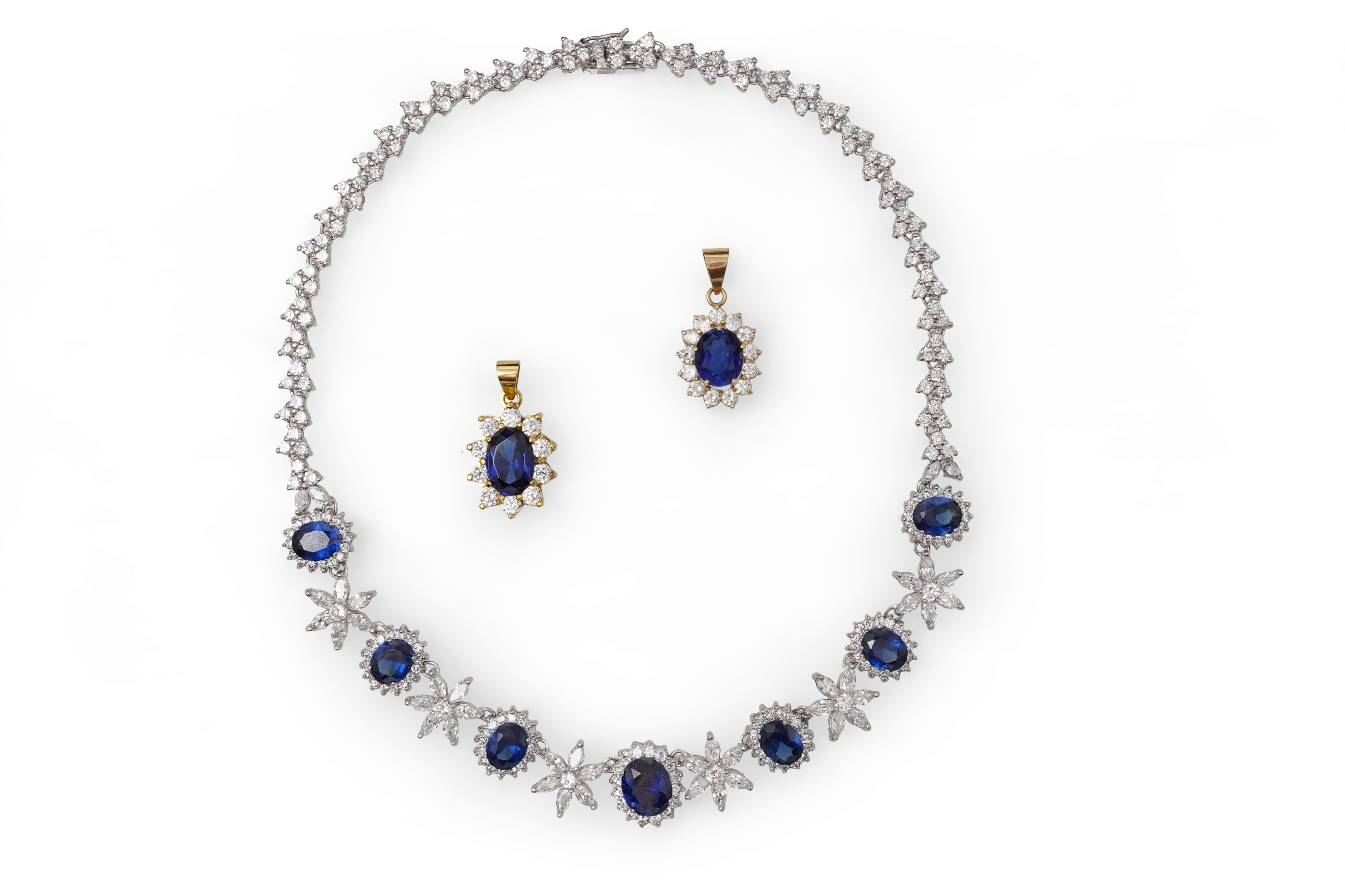 A synthetic sapphire and cubic zirconia necklace and two pendants, the necklace set with oval synthetic sapphires and brilliant-cut and marquise-shaped cubic zirconias, mounted in silver, length 44cm, stamped 925; togeth